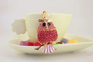 Close-up of pink rhinestone owl keychain with gold-tone metal and crystal details