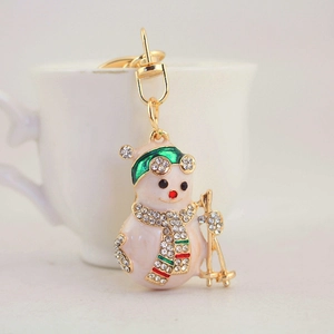 Cute Christmas snowman keychain with rhinestones and white enamel on a gold metal base