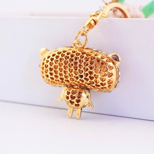 Golden panda keychain with sparkling rhinestones and heart-shaped hollow design on white background