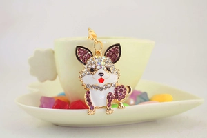 Makroaufnahme vom lila Strass-Hundeanhänger mit goldener Metallöse und Karabinerverschluss