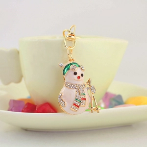 Cute Christmas snowman keychain with colorful rhinestones on a golden metal base