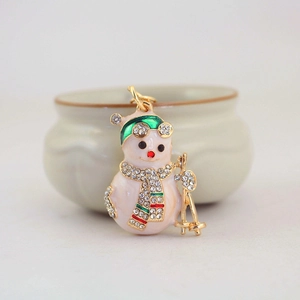 Christmas snowman keychain with white rhinestones and striped scarf on gold metal base