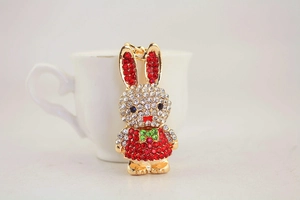Detail of cute long-eared rabbit keychain with red and green sparkling rhinestones