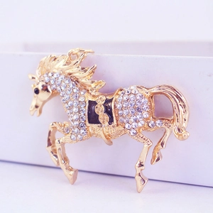 Sparkling crystal encrusted horse keychain in gold finish with black enamel saddle detail