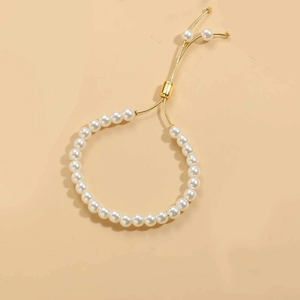 Detail of adjustable pearl bracelet with 14K gold plated clasp and round white pearls