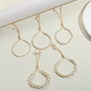 Detail of five-piece 14K gold plated pearl bracelets with adjustable sliding gold buckles