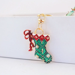 Christmas stocking keychain with red bow and rhinestones in gold-plated metal finish