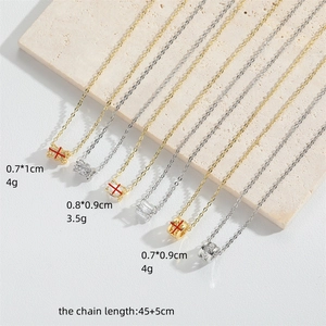 Minimalist trumpet pendant necklaces set with cubic zirconia and gold finish