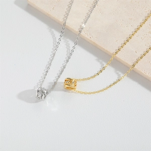 Minimalist gold and silver horn pendants with zircon inlays on delicate link chains
