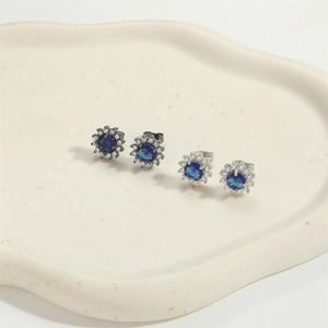 Minimalist sunflower zircon stud earrings set in silver and black metal finishes