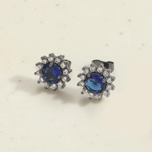 Detail of sunburst earrings with navy blue central stone and sparkling crystal halo