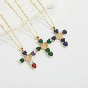 Detail of cross necklace with heart-shaped colorful zircons and embossed pendant