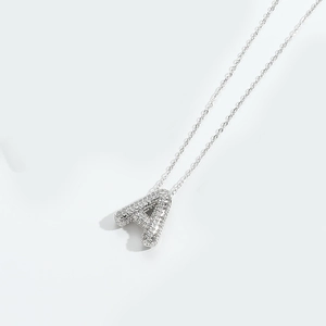 Detailed close-up of a silver Gothic letter A pendant with shimmering micro-pave zircons