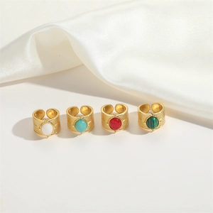 Detailed view of adjustable gold-plated mesh rings set with colorful natural stones