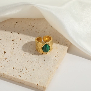 Adjustable gold ring with oval green malachite gemstone and textured woven metal band