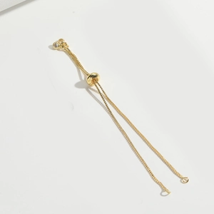 Close-up of adjustable gold slider chain with box links and polished bead for jewelry making