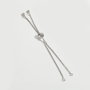 Detail of silver box chain bracelet with adjustable bolo clasp and tiny white diamonds
