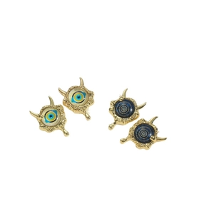 Vintage copper evil eye earrings with blue resin details and golden textured frames