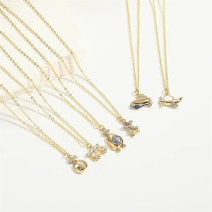 Detailed view of six gold-plated travel themed pendants with colorful enamel and zircons
