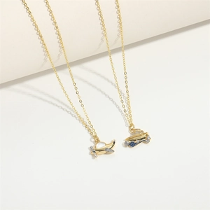 Minimalist gold airplane and ship pendants on O-chains with enamel and crystals