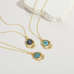 14K gold plated evil eye pendant necklaces with resin blue eyes on white marble background