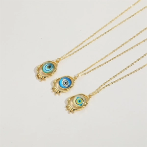 Detailed view of three 14K gold plated evil eye necklaces in assorted resin colors