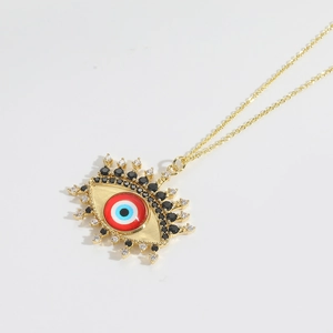 Macro shot of gold necklace with detailed Evil Eye pendant and colorful sparkling crystals
