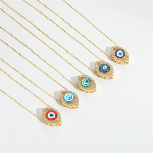 Detail view of five evil eye necklaces with colorful crystal centers and gold plating