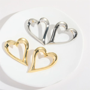 Modern hollow heart-shaped earrings in gold and silver metal with geometric design