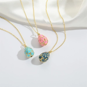 Vintage Faberge style egg pendants with golden filigree on elegant white satin