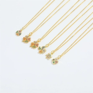Close-up of golden necklace set featuring colorful zircon windmill and clover pendants