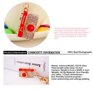 Detailed close-up of a red camera keychain with sparkling rhinestones and zinc alloy base