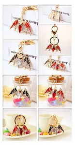 Close-up of cute crystal bat keychain with sparkling rhinestones on golden metal