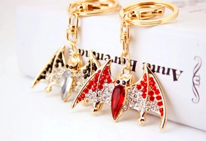 Detailed macro view of crystal bat keychains with sparkling rhinestones and gold alloy base
