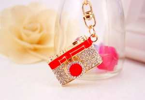 Detailed view of creative camera keychain featuring red enamel and sparkling rhinestones