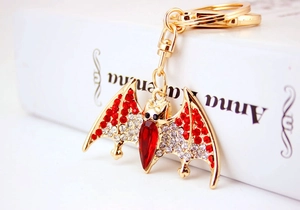 Detail view of crystal-encrusted bat keychain with red main stone and gold-tone alloy