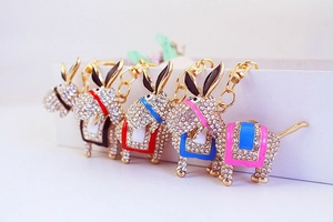 Detailed view of rhinestone donkey keychains with colorful enamel saddles and gold hooks