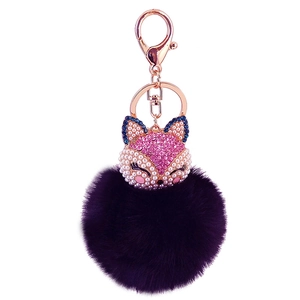 Detailed close-up of dark purple rabbit fur fox head keychain with rhinestones and pearls