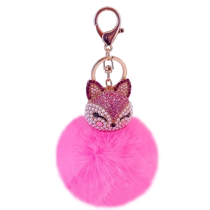Close-up of pink fox head faux fur keychain with sparkling rhinestones and rose gold hardware