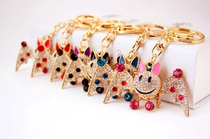 Close-up of sparkling rhinestone bat keychains in various colors with metallic finish