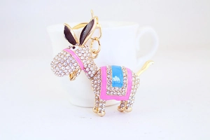 Close-up of sparkling rhinestone donkey keychain with pink and blue enamel details