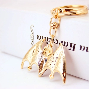 Creative gold bat keychain with crystal accents and textured wings for handbags