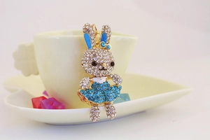 Dettaglio di un portachiavi a coniglio dorato con strass blu e bianchi molto brillanti