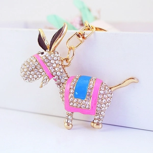 Sparkling rhinestone donkey keychain with pink enamel accents and gold metal finish