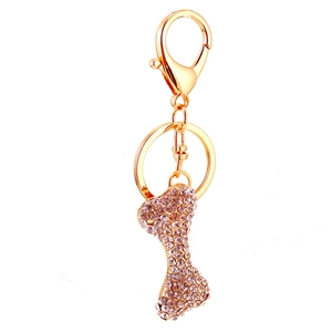 Detailed close-up of sparkling rhinestone bone keychain with gold-plated spring clasp