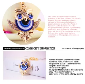 Close-up of golden owl keychain with blue evil eye patterns and Czech rhinestones