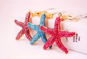 Macro shot of rhinestone-encrusted starfish keychains in pink, blue and red crystal