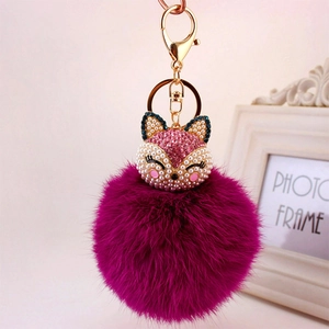 Plush fox head keychain in magenta faux fur with crystal embellishments and gold ring