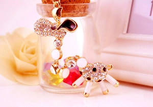 Detail of golden giraffe keychain with sparkling rhinestones and black enamel accents