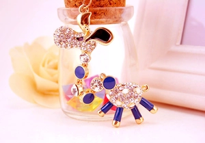Detailed view of the sparkling white rhinestone sheep keychain with gold alloy finish
